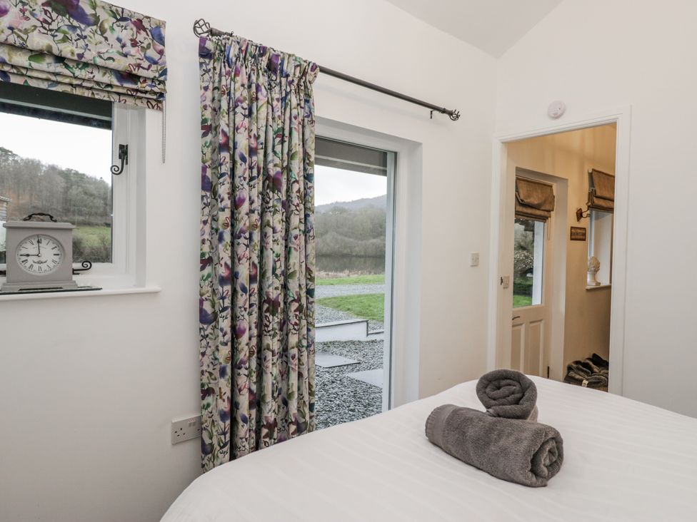 A bedroom with a bed and window at The Dove Cot in Ambleside