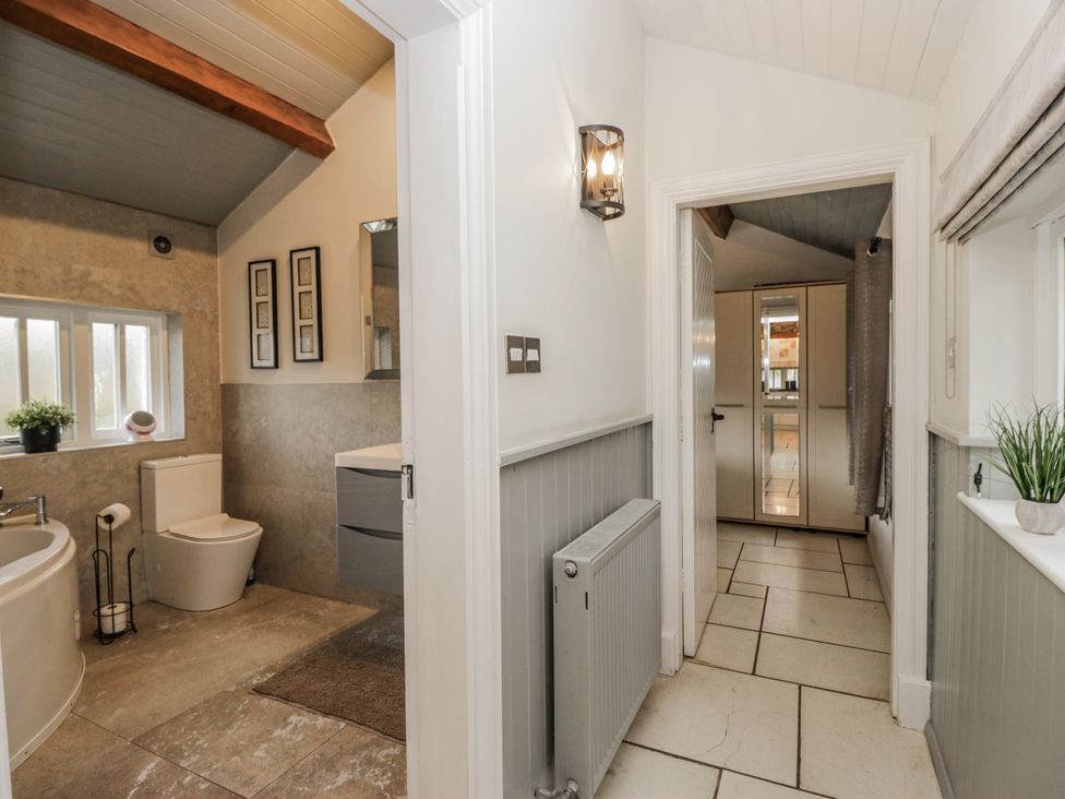 A bathroom with a bathtub and toilet at The Dove Cot in Ambleside
