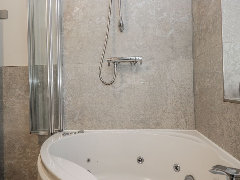 A bathroom with a bathtub and shower at The Dove Cot in Ambleside