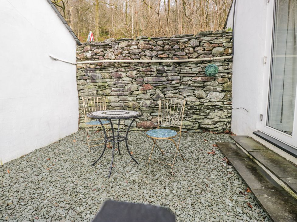 An outdoor area with a table and two chairs at The Dove Cot in Ambleside