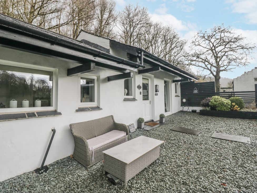 An outdoor area with a bench and table at The Dove Cot in Ambleside