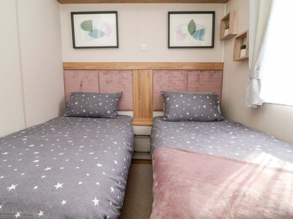 A bedroom with two beds at Presthaven Sands in Prestatyn