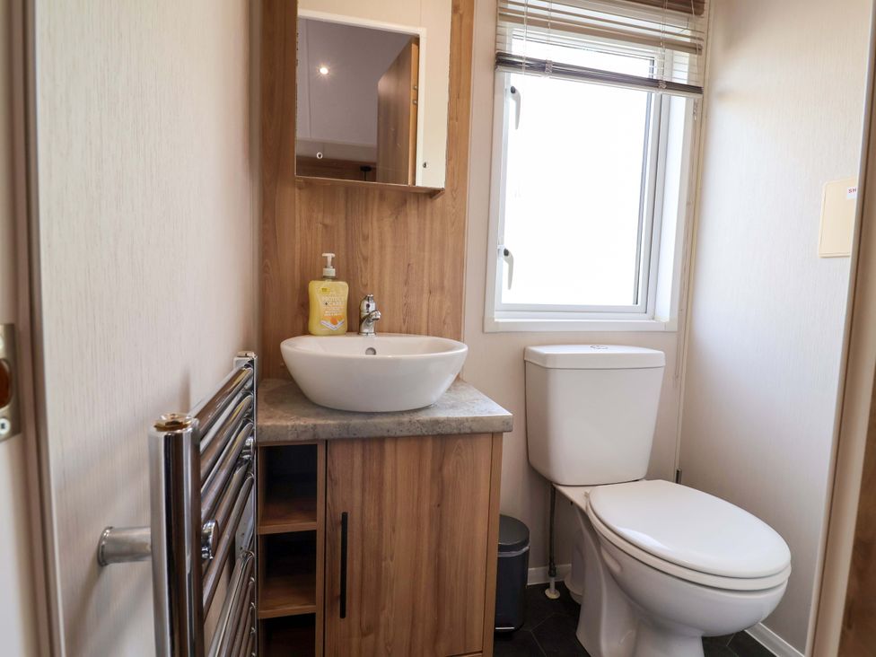 A bathroom with sink and toilet at Presthaven Sands in Prestatyn