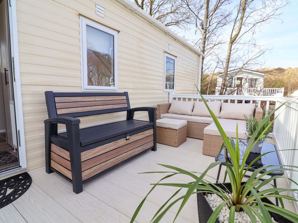 A patio with bench and sofa at Presthaven Sands in Prestatyn