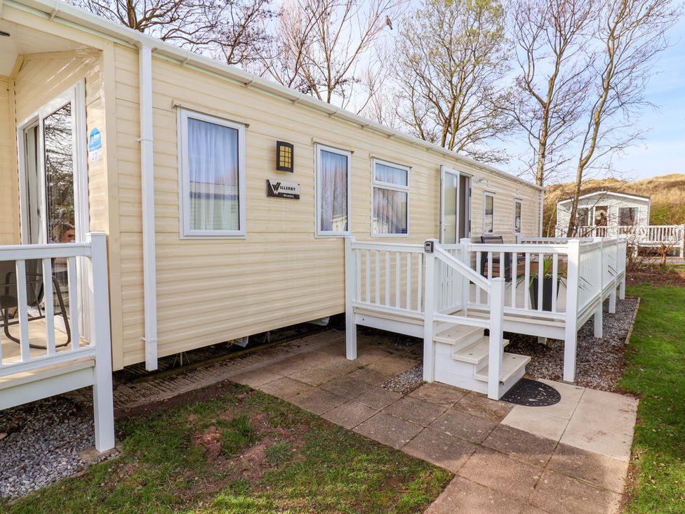A mobile home with steps and decking at Presthaven Sands in Prestatyn