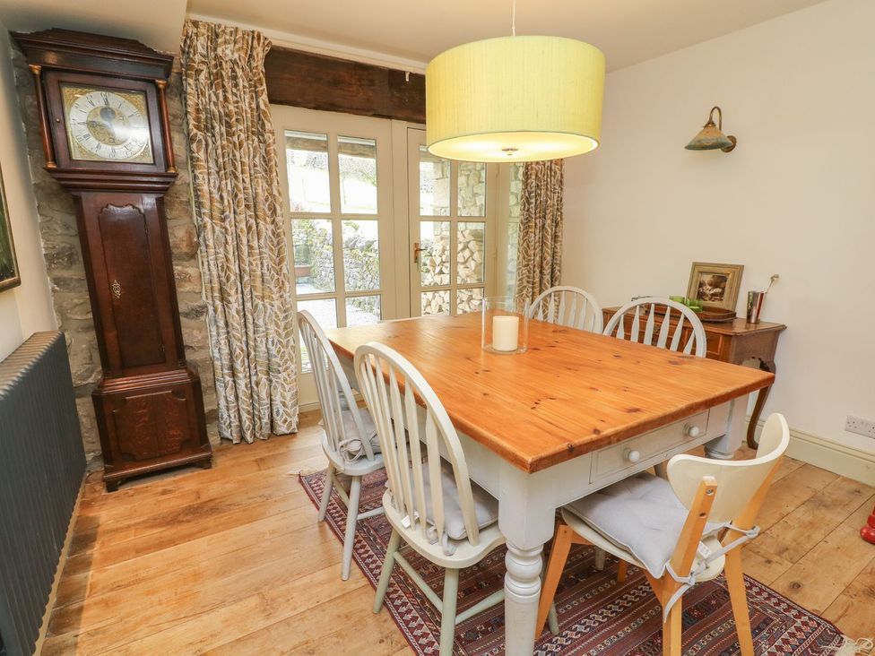 A dining room with a table and chairs at Litton Hall Barn Cottage in Skipton