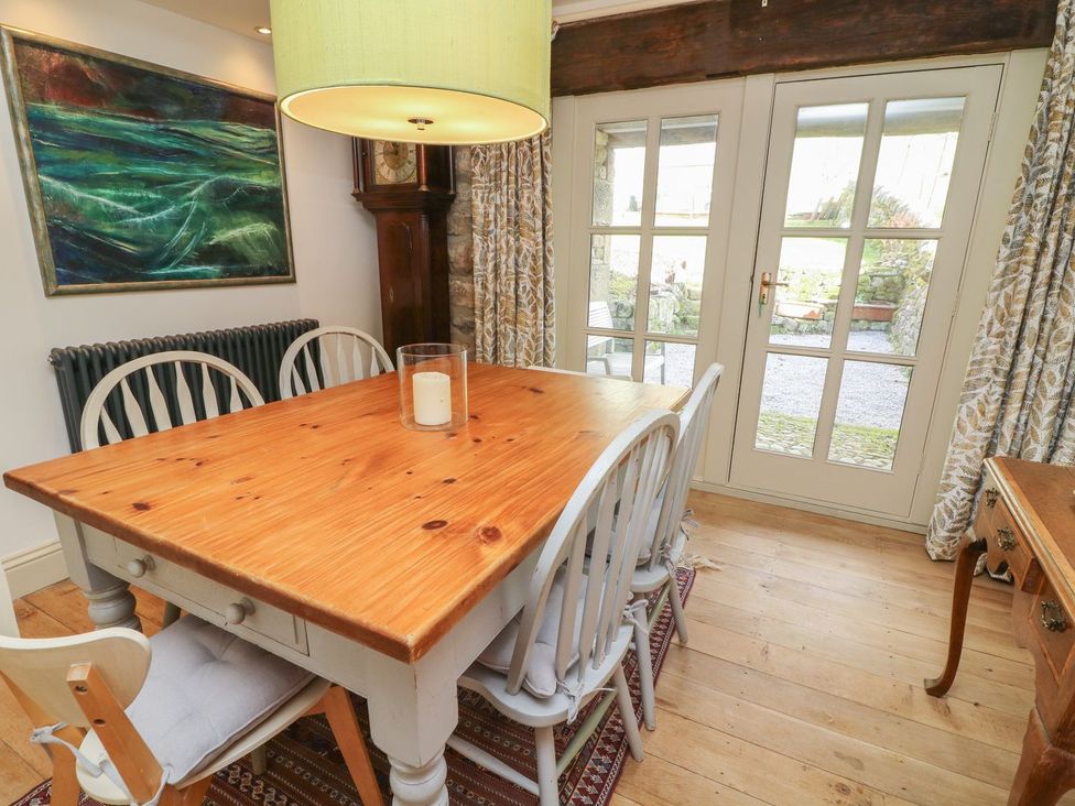 A dining room with a table and chairs at Litton Hall Barn Cottage in Skipton