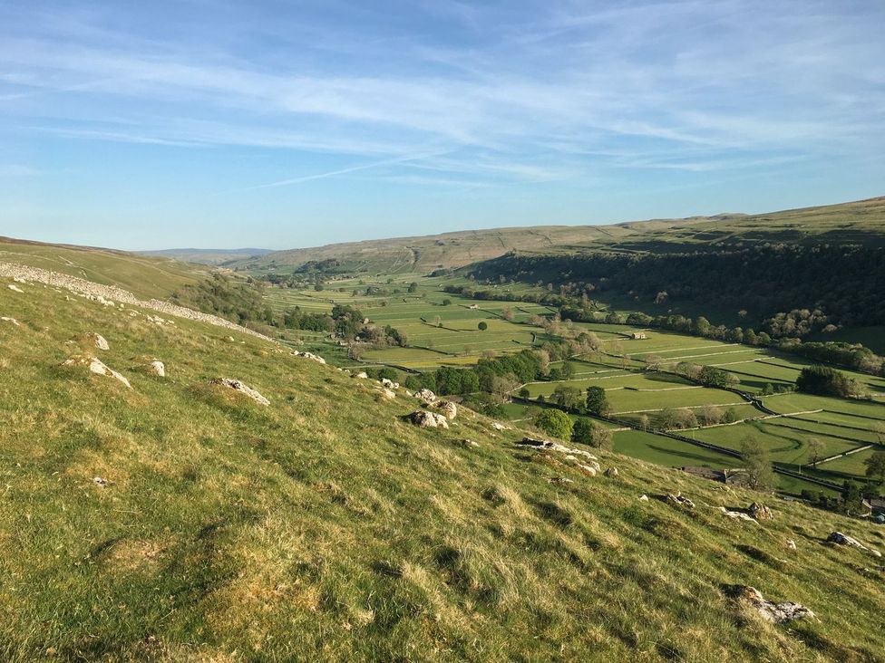A landscape view with hills and fields at Litton Hall Barn Cottage in Skipton