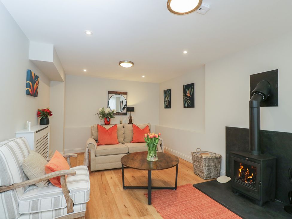 A living room with a coffee table and a fireplace at Paddock View in Stow-On-The-Wold