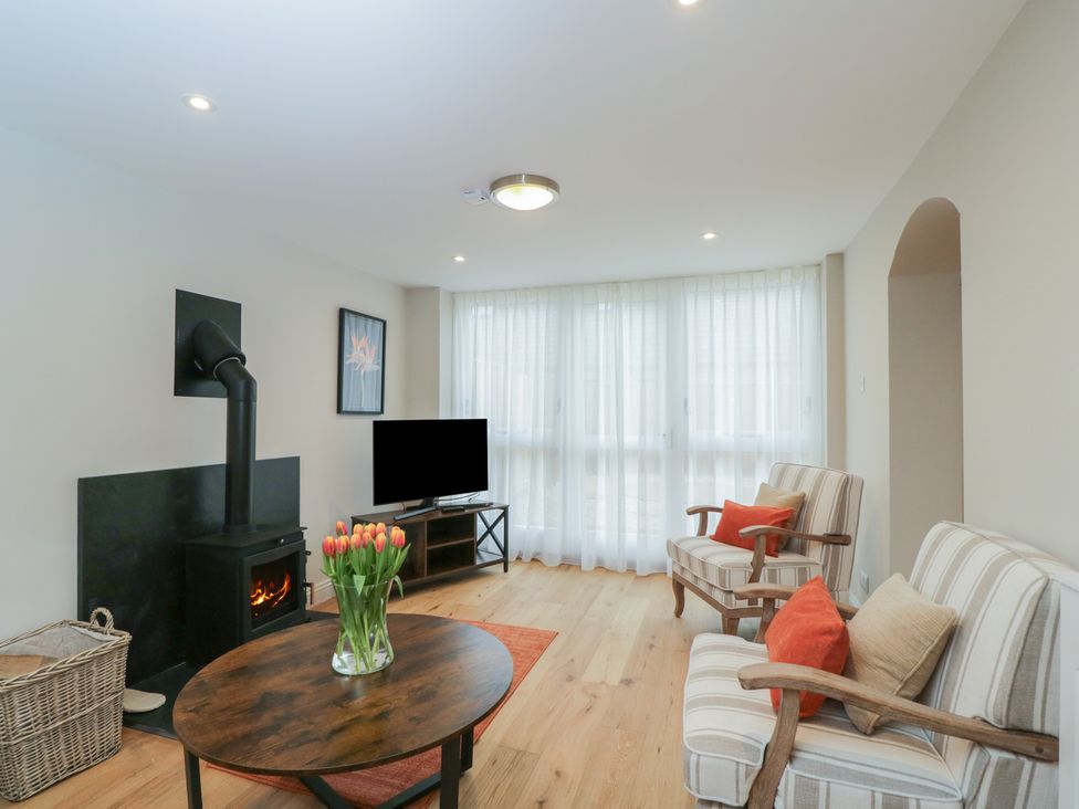 A living room with a fireplace and television at Paddock View Stow-On-The-Wold