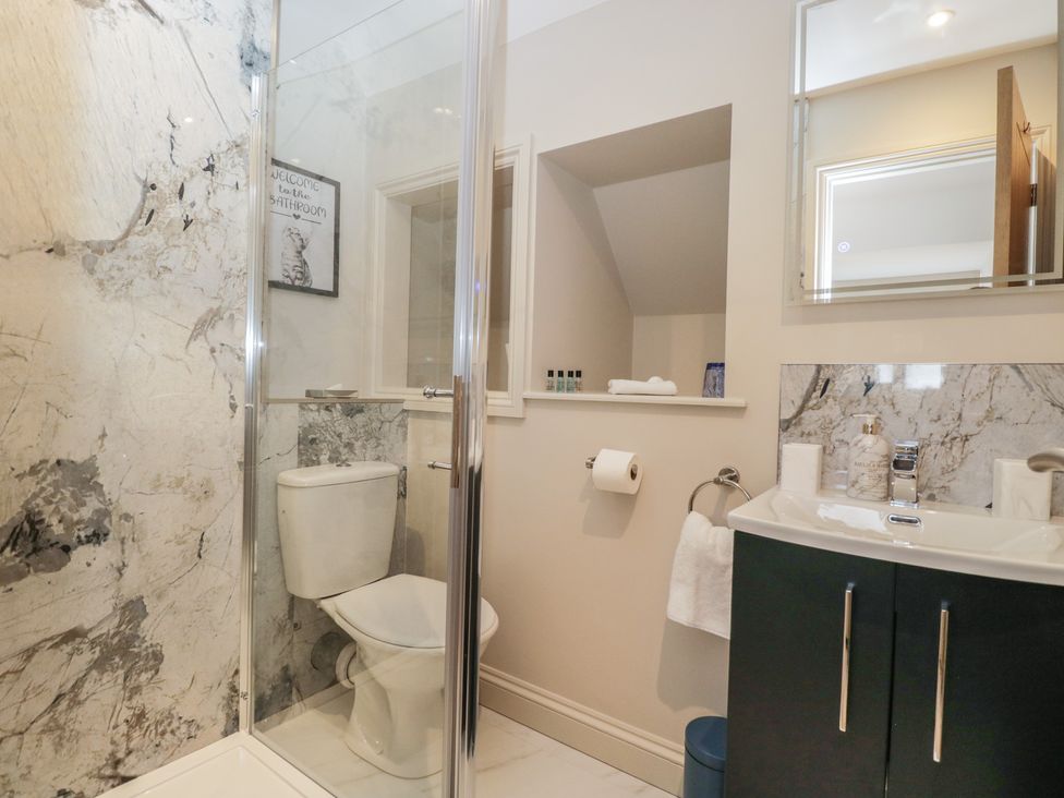 A bathroom with a shower, toilet, and sink at Paddock View in Stow-On-The-Wold