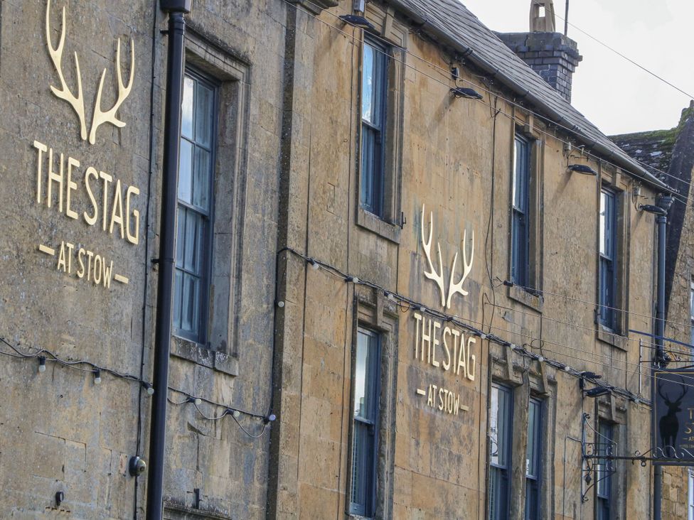 The exterior of The Stag pub with signage in Stow-On-The-Wold