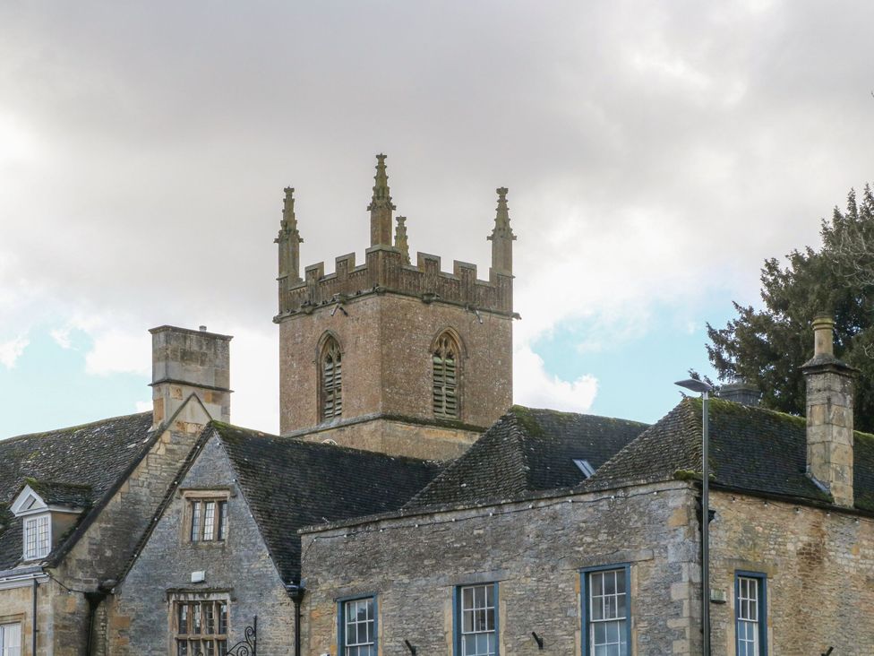 A church tower above a stone building at Paddock View Stow-On-The-Wold