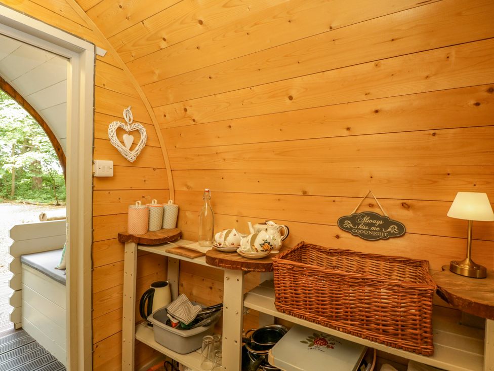 A kitchen with shelves and a tea set at Daisy Glamping Pod in Woolton Hill