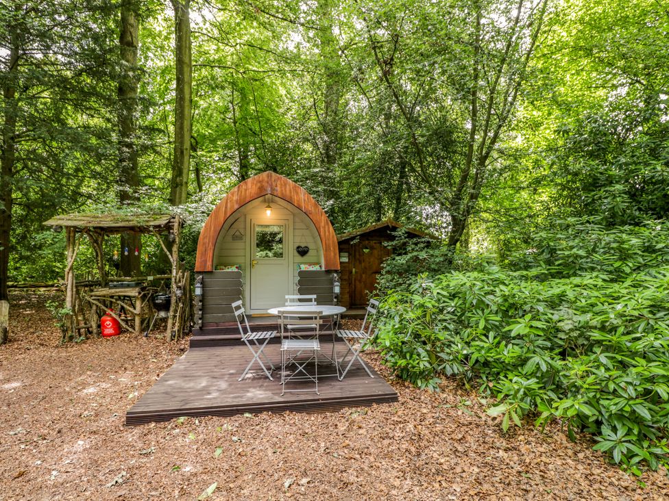A glamping pod with table and chairs at Daisy Glamping Pod in Woolton Hill