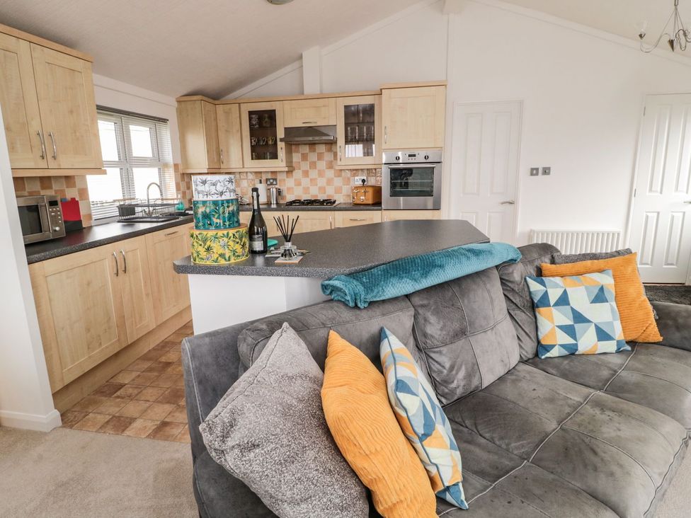 A kitchen with cabinets and appliances at Nevaeh Lodge Longframlington
