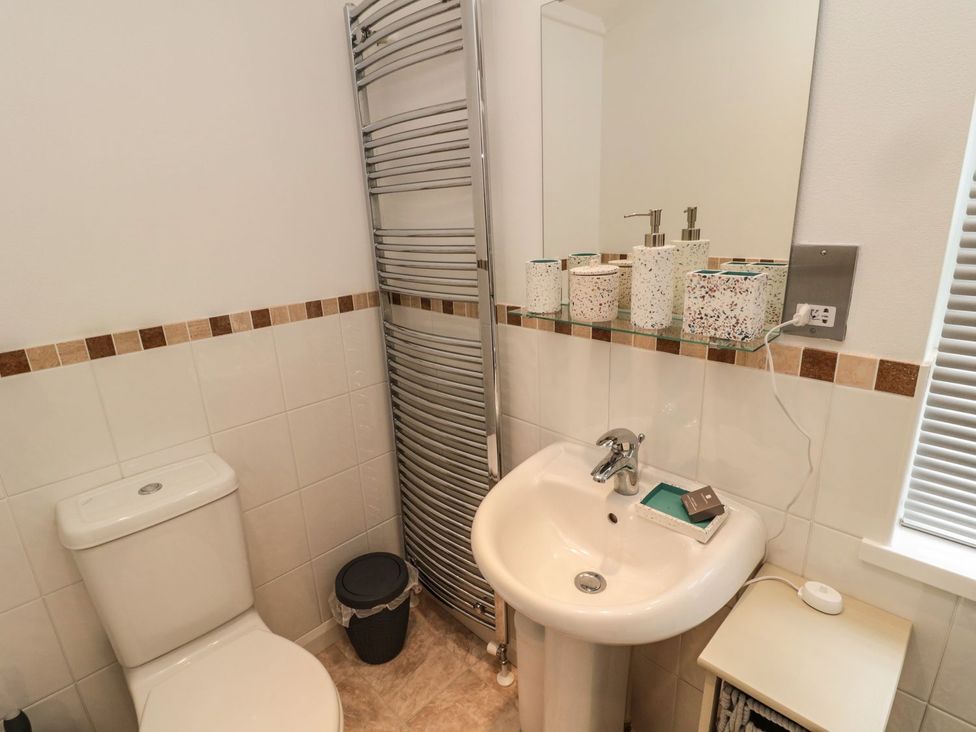 A bathroom with a toilet and sink at Nevaeh Lodge in Longframlington