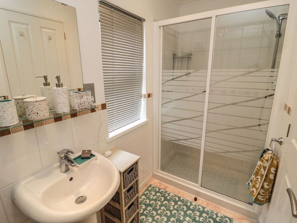 A bathroom with a sink and shower at Nevaeh Lodge Longframlington