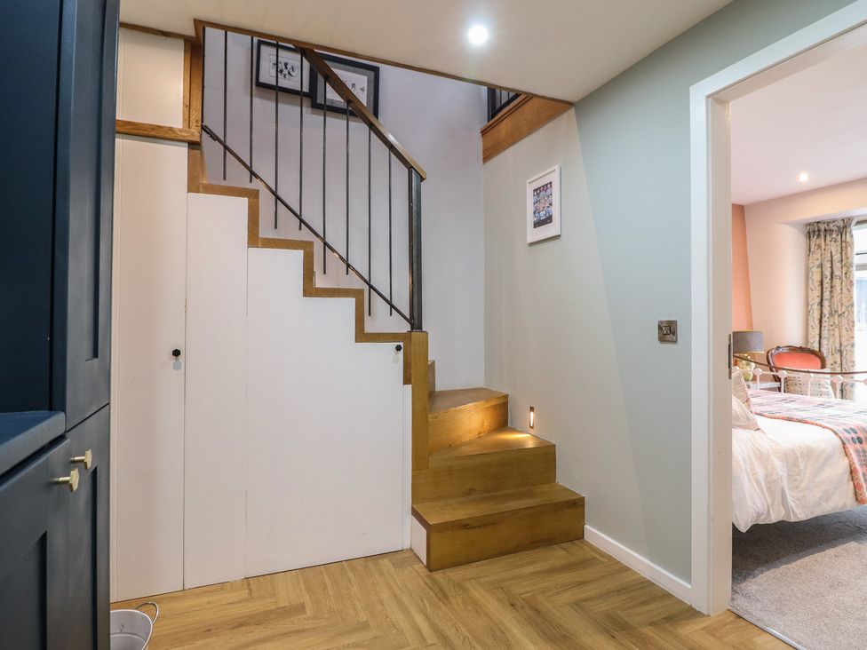 A hallway with a staircase at The Old Cartshed | Yr Hen Gwt Cart in Abergele