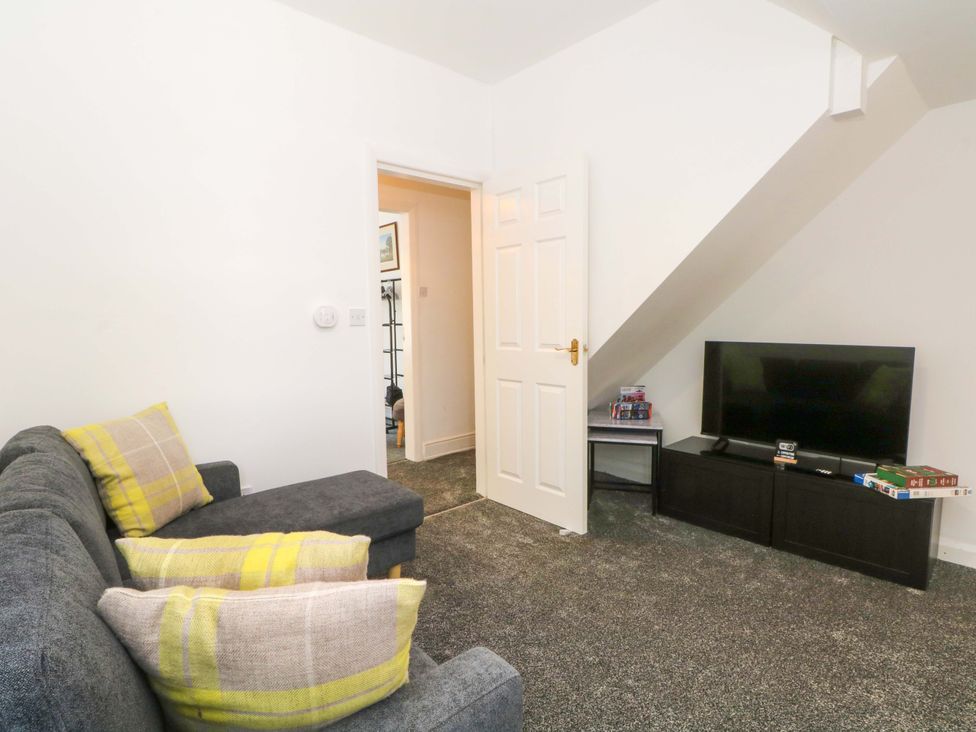 A living room with a sofa and a television at 4 Newton Terrace in Lancaster