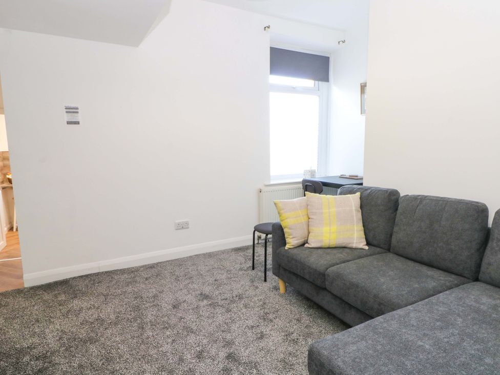 A living room with a sofa and chair at 4 Newton Terrace in Lancaster
