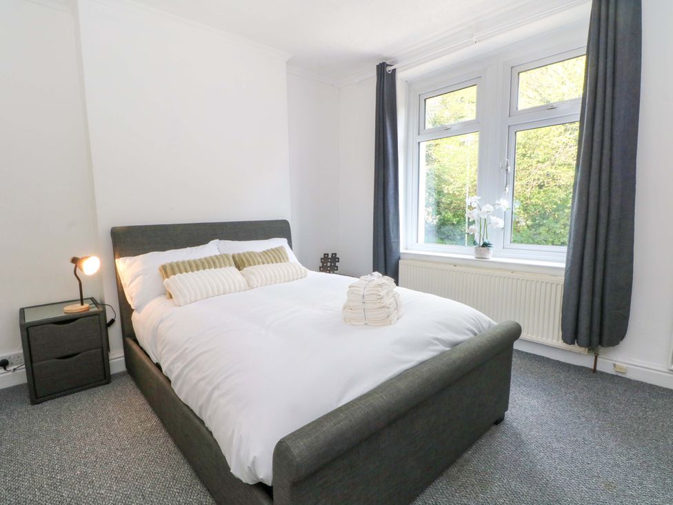 A bedroom with a bed and nightstand at 4 Newton Terrace in Lancaster