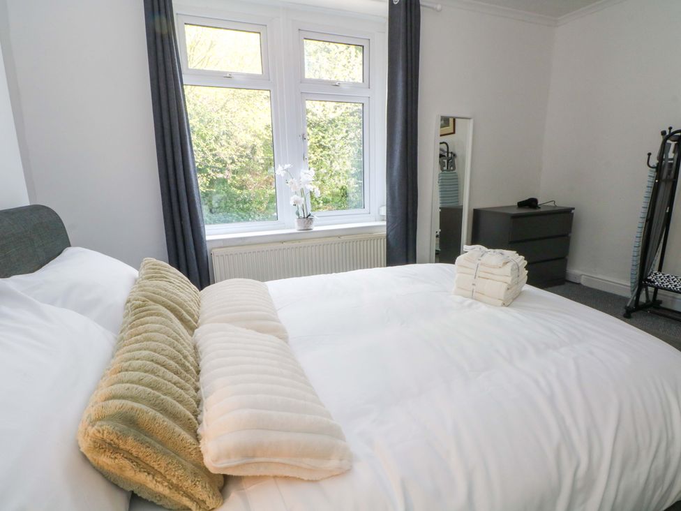 A bedroom with a bed and dresser at 4 Newton Terrace in Lancaster
