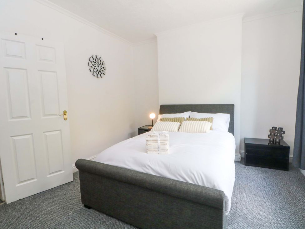 A bedroom with a bed and bedside table at 4 Newton Terrace in Lancaster