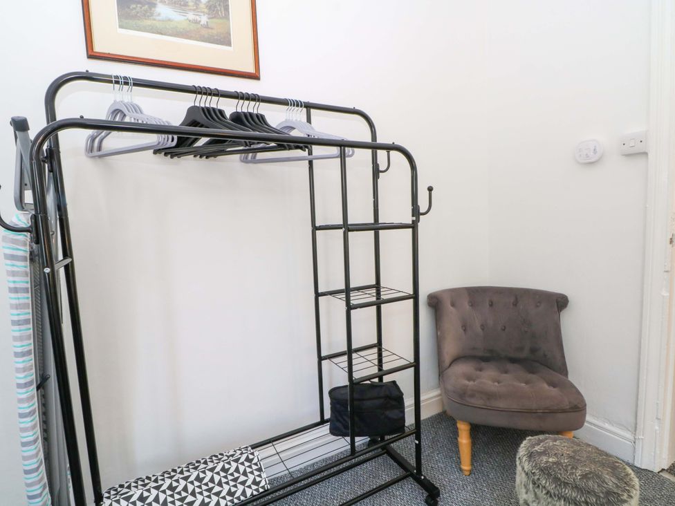 A closet with clothes rack and small chair at 4 Newton Terrace in Lancaster