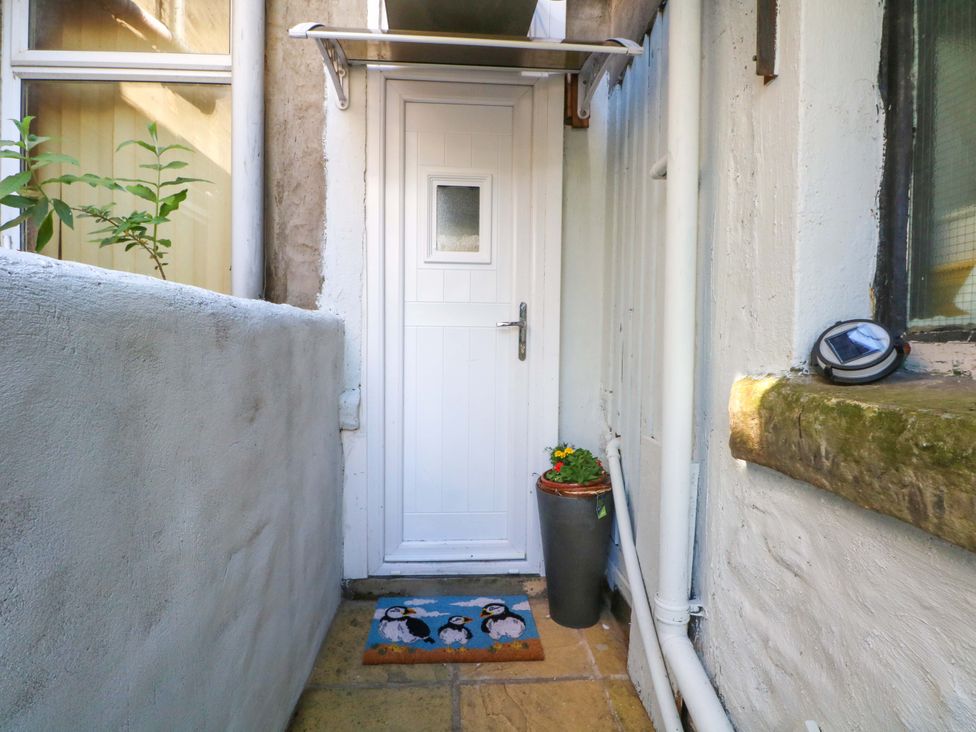 An entrance area with a white door and doormat at 4 Newton Terrace Lancaster