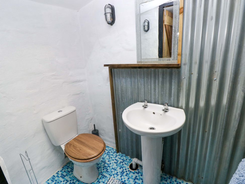 A bathroom with a toilet and sink at Woodpecker in Haverfordwest