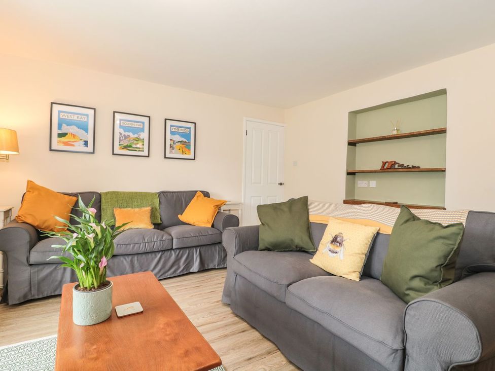A living room with sofas and wall art at Ammerham Farm Cottage in Ammerham near Winsham
