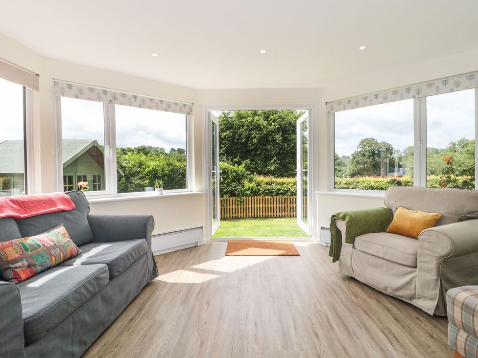 A sitting room with sofas and large windows at Ammerham Farm Cottage Ammerham near Winsham