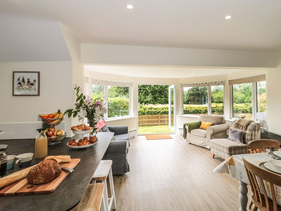 A kitchen with seating area and fruit on the counter at Ammerham Farm Cottage Ammerham near Winsham