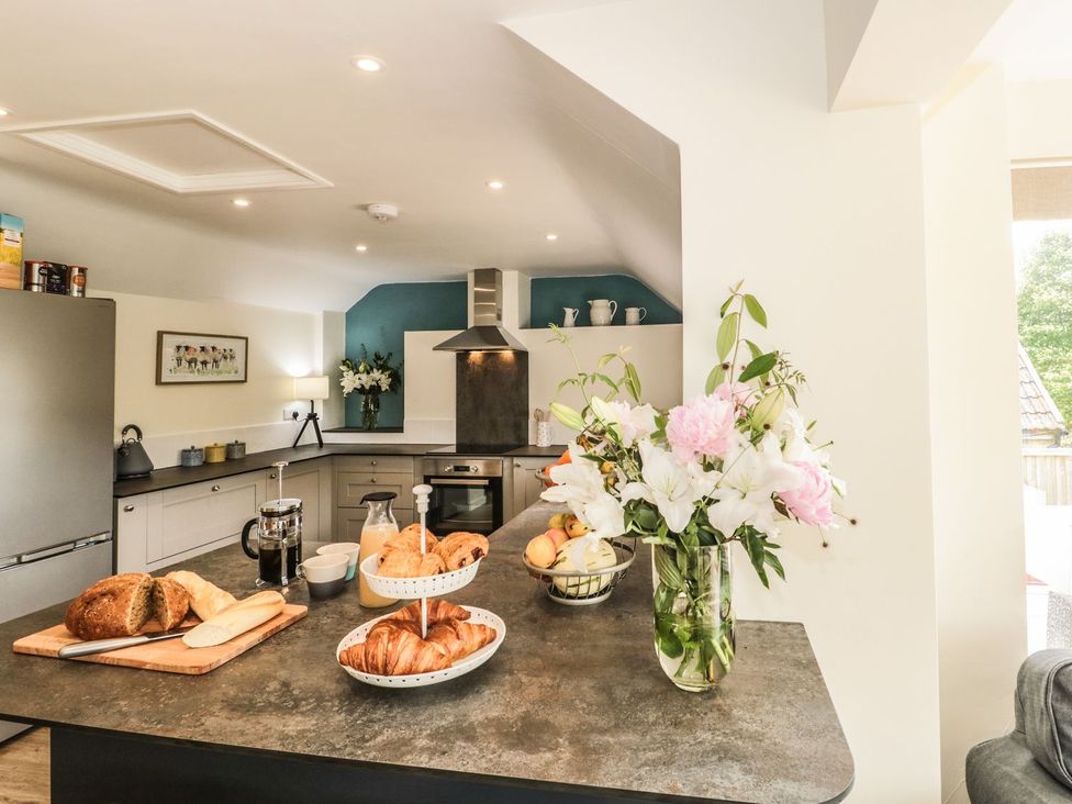 A kitchen with a counter and various food items at Ammerham Farm Cottage in Ammerham near Winsham