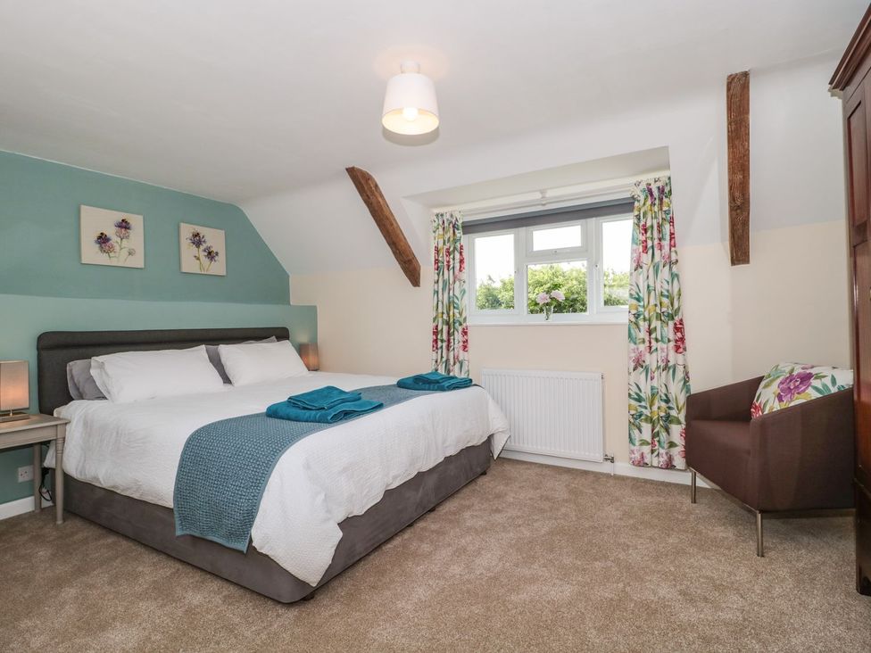 A bedroom with a bed and decorative curtains at Ammerham Farm Cottage Ammerham near Winsham