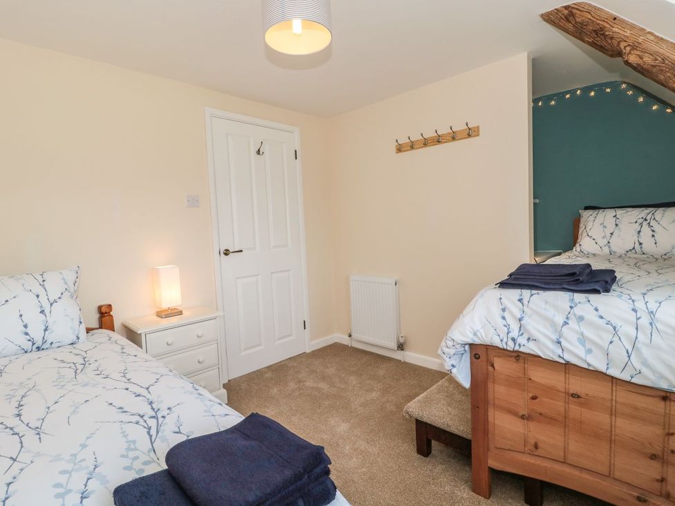A bedroom with two beds and a lamp at Ammerham Farm Cottage Ammerham near Winsham