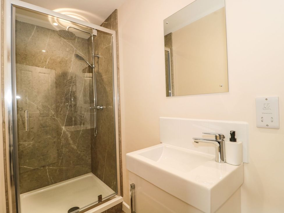 A bathroom with a shower and sink at Ammerham Farm Cottage in Ammerham near Winsham