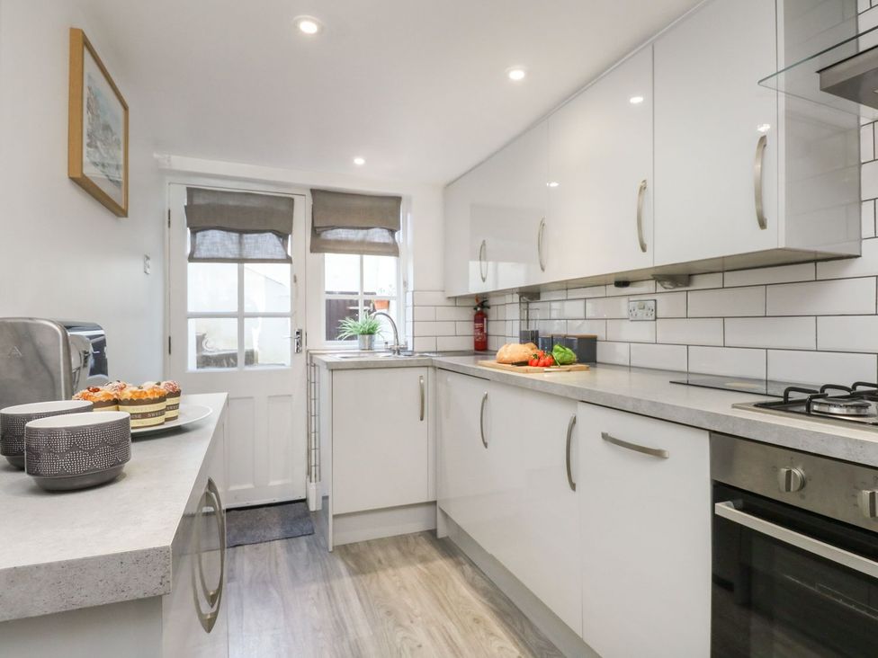 A kitchen with stove and sink at Ocean Wave in Greenhill