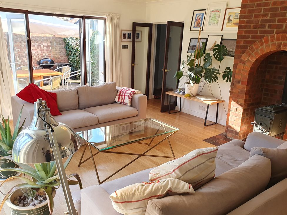 A living room with a table and sofa at Island Retreat in Colchester