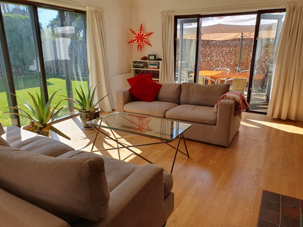 A snug with sofas and a glass table at Island Retreat in Colchester