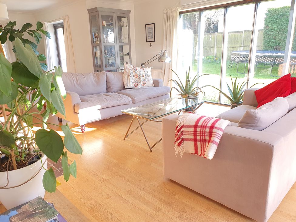 A living room with sofas and a glass coffee table at Island Retreat in Colchester