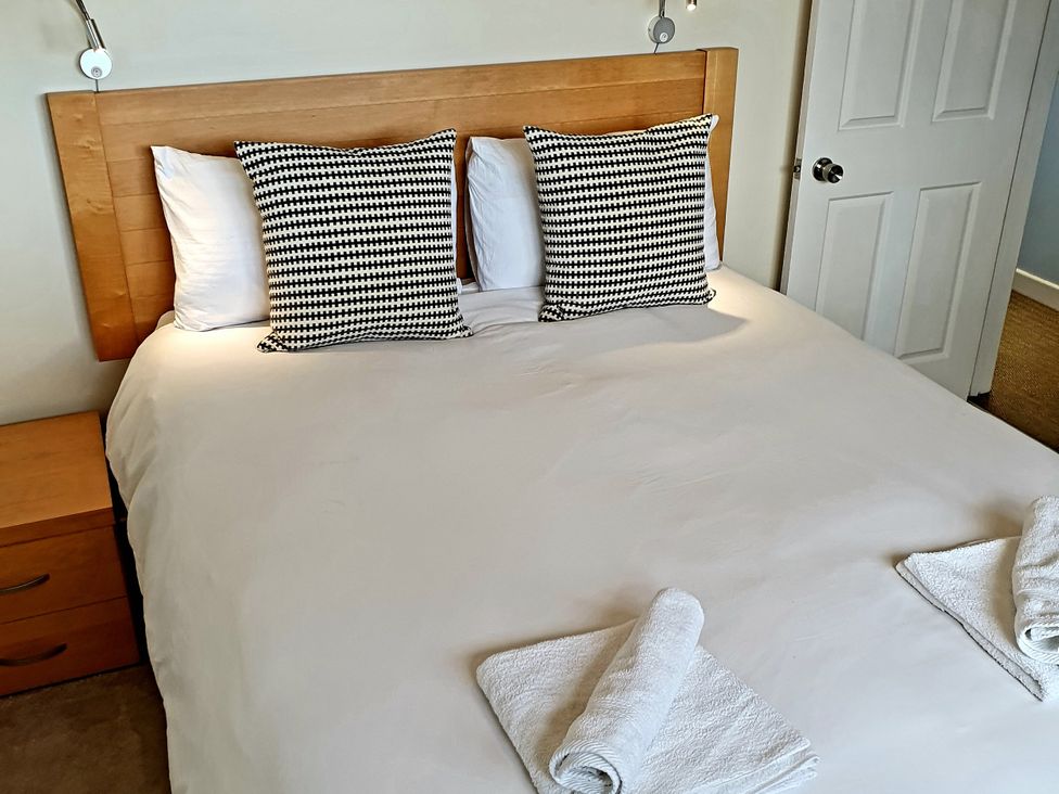 A bedroom with a bed and bedside table at Island Retreat in Colchester