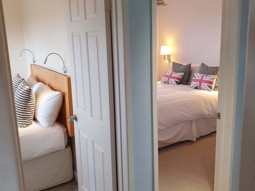 A bedroom with two beds and decorative pillows at Island Retreat in Colchester