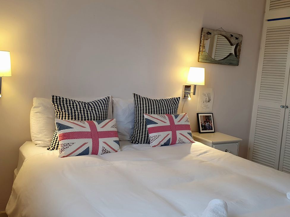 A bedroom with a bed and decorative pillows at Island Retreat in Colchester