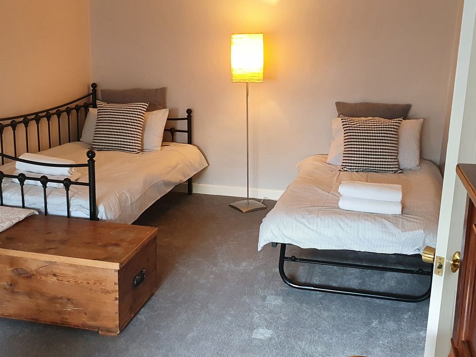 A bedroom with two beds and a floor lamp at Island Retreat in Colchester