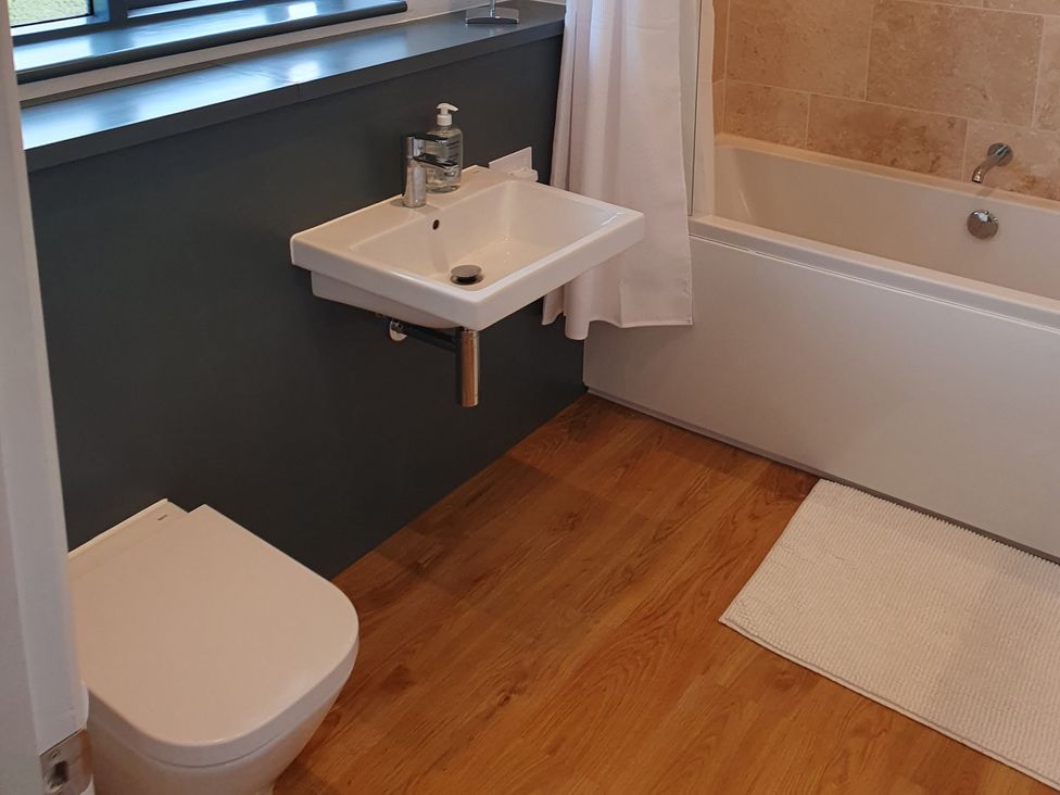 A bathroom with a sink and bathtub at Island Retreat in Colchester