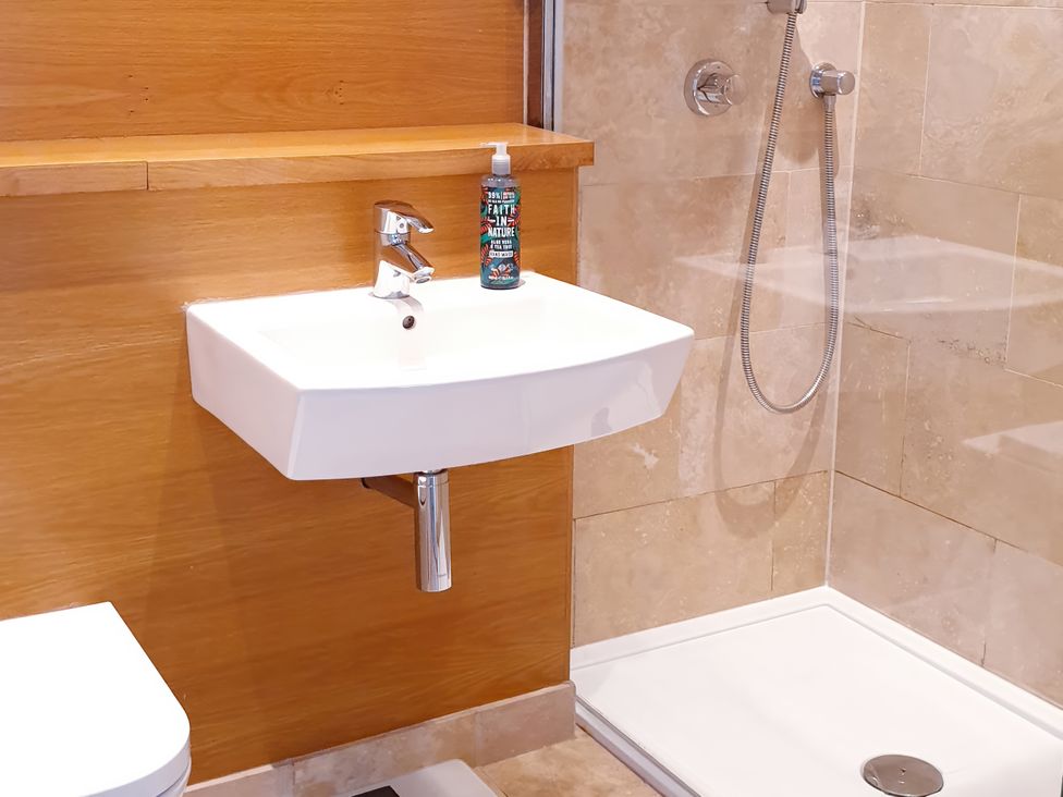 A bathroom with sink and shower fittings at Island Retreat in Colchester