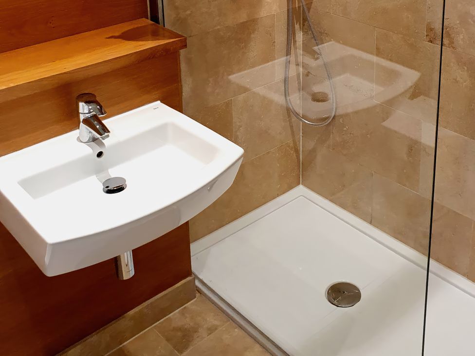 A bathroom with a sink and a shower at Island Retreat in Colchester