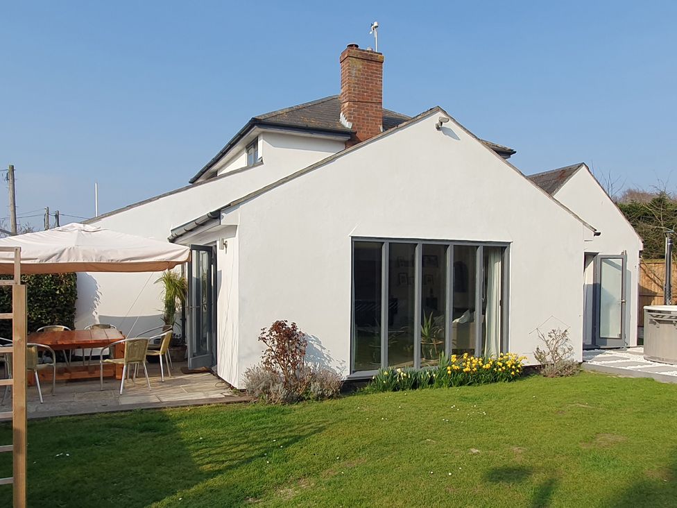 A house with a dining area and garden at Island Retreat in Colchester